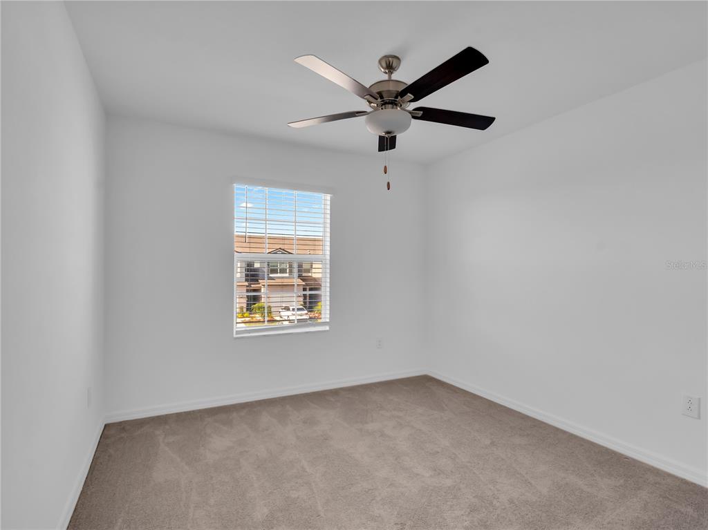 12408 Crystal Jade Way Parrish, FL 34219 - Photo 4 of 51 an empty room with a window and a fan