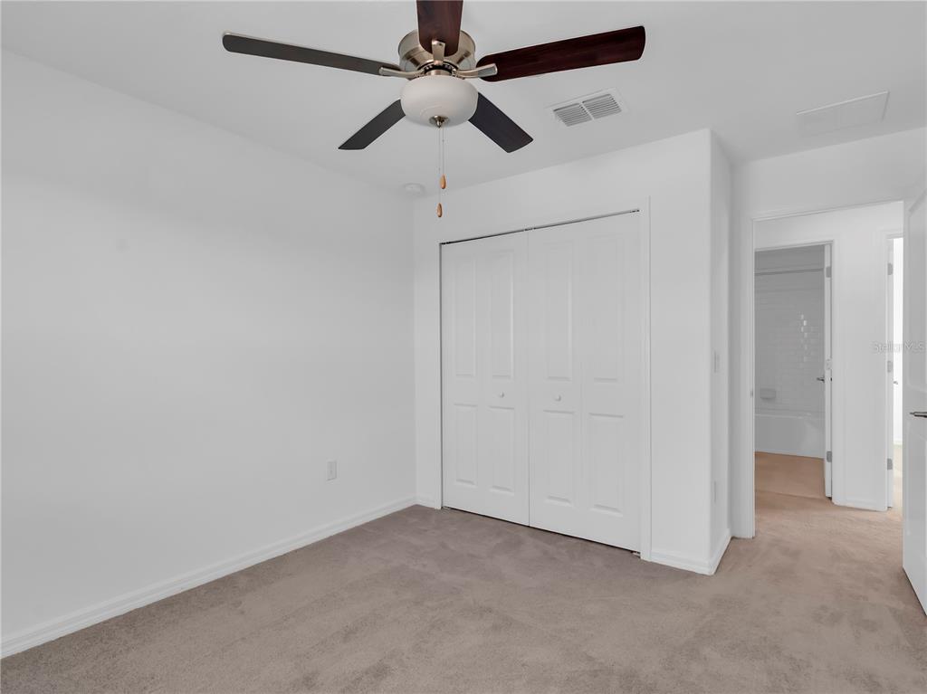 12408 Crystal Jade Way Parrish, FL 34219 - Photo 5 of 51 an empty room with fan