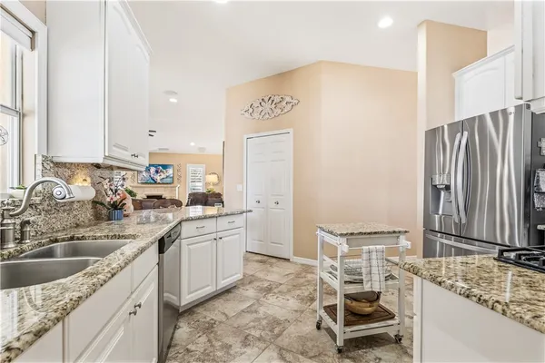 a kitchen with a sink stove and refrigerator