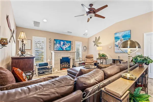 a living room with furniture a fireplace and a flat screen tv