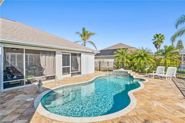 a view of a house with swimming pool and sitting area