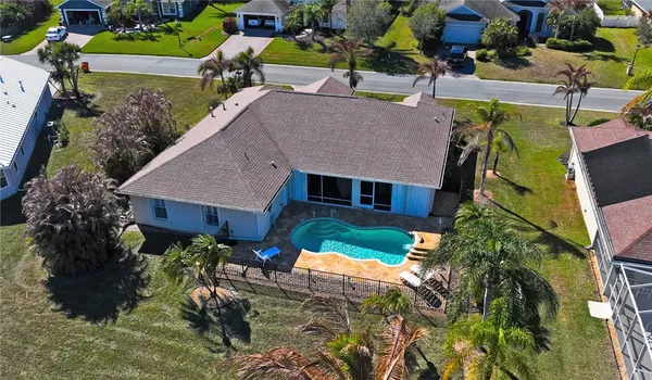 a aerial view of a house with a yard patio and fire pit
