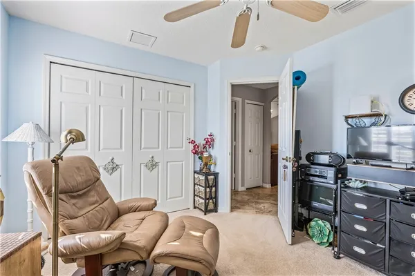 a living room with furniture a desk and chair