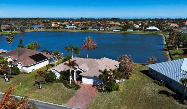 an aerial view of a house with a lake view