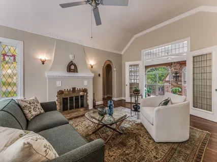 a living room with furniture fireplace and a large window