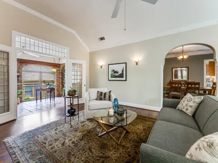 a living room with furniture and wooden floor