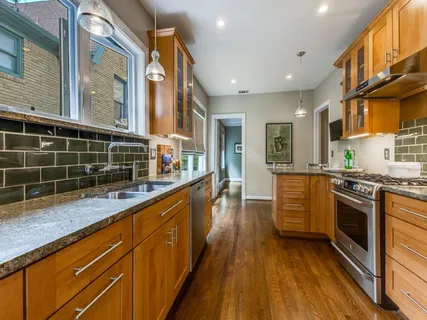 a living room with stainless steel appliances kitchen island granite countertop furniture and a kitchen view