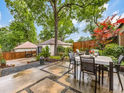 a wooden bench sitting in backside of a house