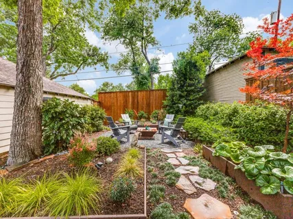 a view of backyard with seating space and trees