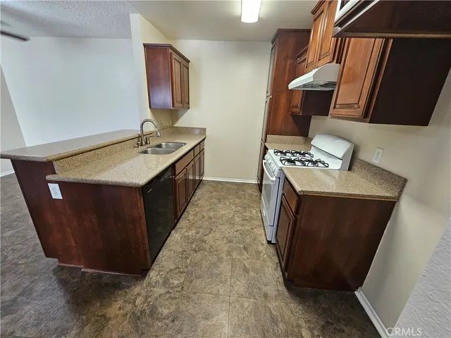 a kitchen with sink stove and cabinets