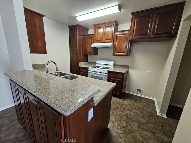 a kitchen with sink cabinets and microwave