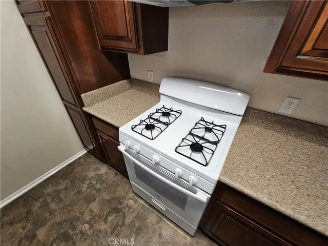 a stove top oven sitting inside of a kitchen