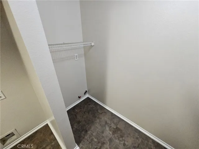 a front view of a house with a yard and potted plants