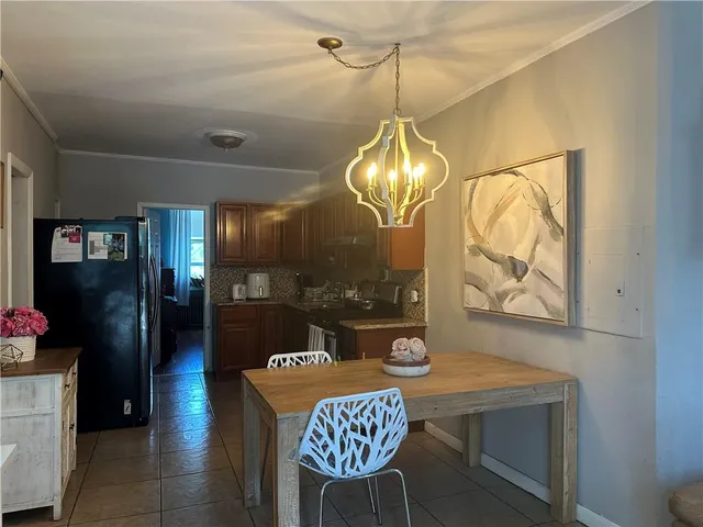 a kitchen with a table and chandelier