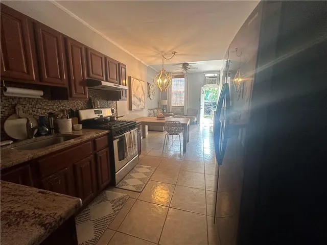 a kitchen with a sink a stove and cabinets