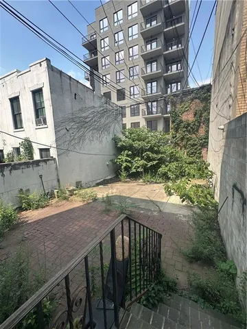 a view of a brick house with a small yard