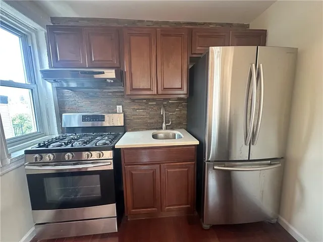 a kitchen with a stove refrigerator and microwave