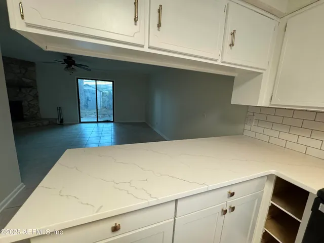 a kitchen with a sink appliances and cabinets