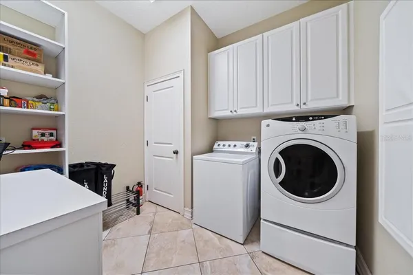 a kitchen with stainless steel appliances granite countertop a refrigerator and wooden cabinets