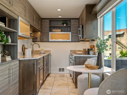 a living room with a couch and a potted plant
