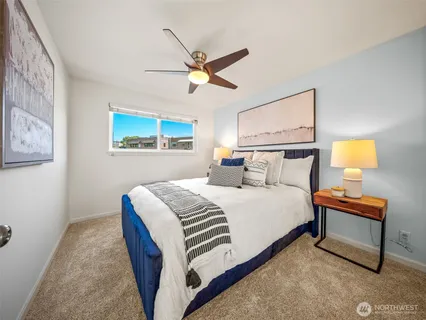 a bedroom with a bed and lamp with window