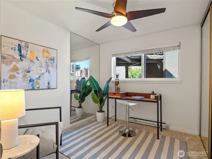 a workspace room with furniture and wooden floor
