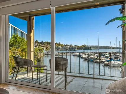 a balcony with table and chairs