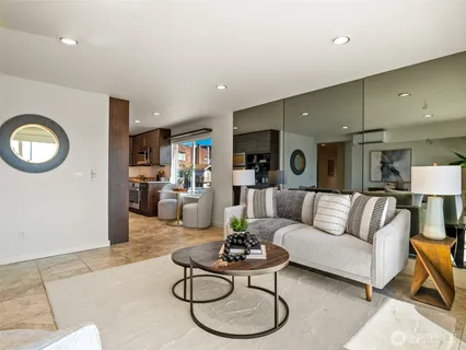 a living room with furniture kitchen view and a table
