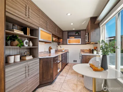 a kitchen with a stove a refrigerator and a wooden cabinets