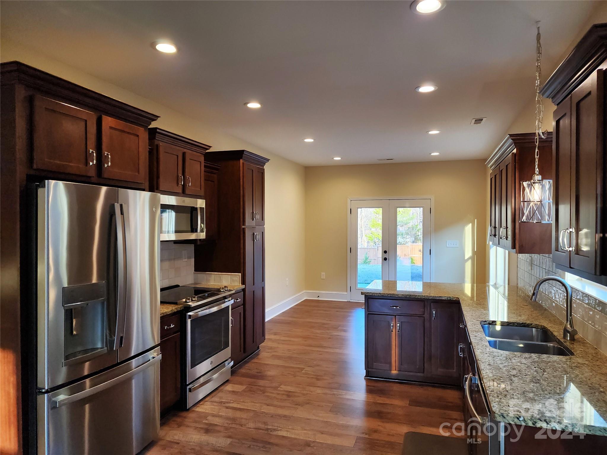 502 Tryon Street Greer, SC 29651 - Photo 5 of 31 a kitchen with stainless steel appliances granite countertop a refrigerator stove and oven