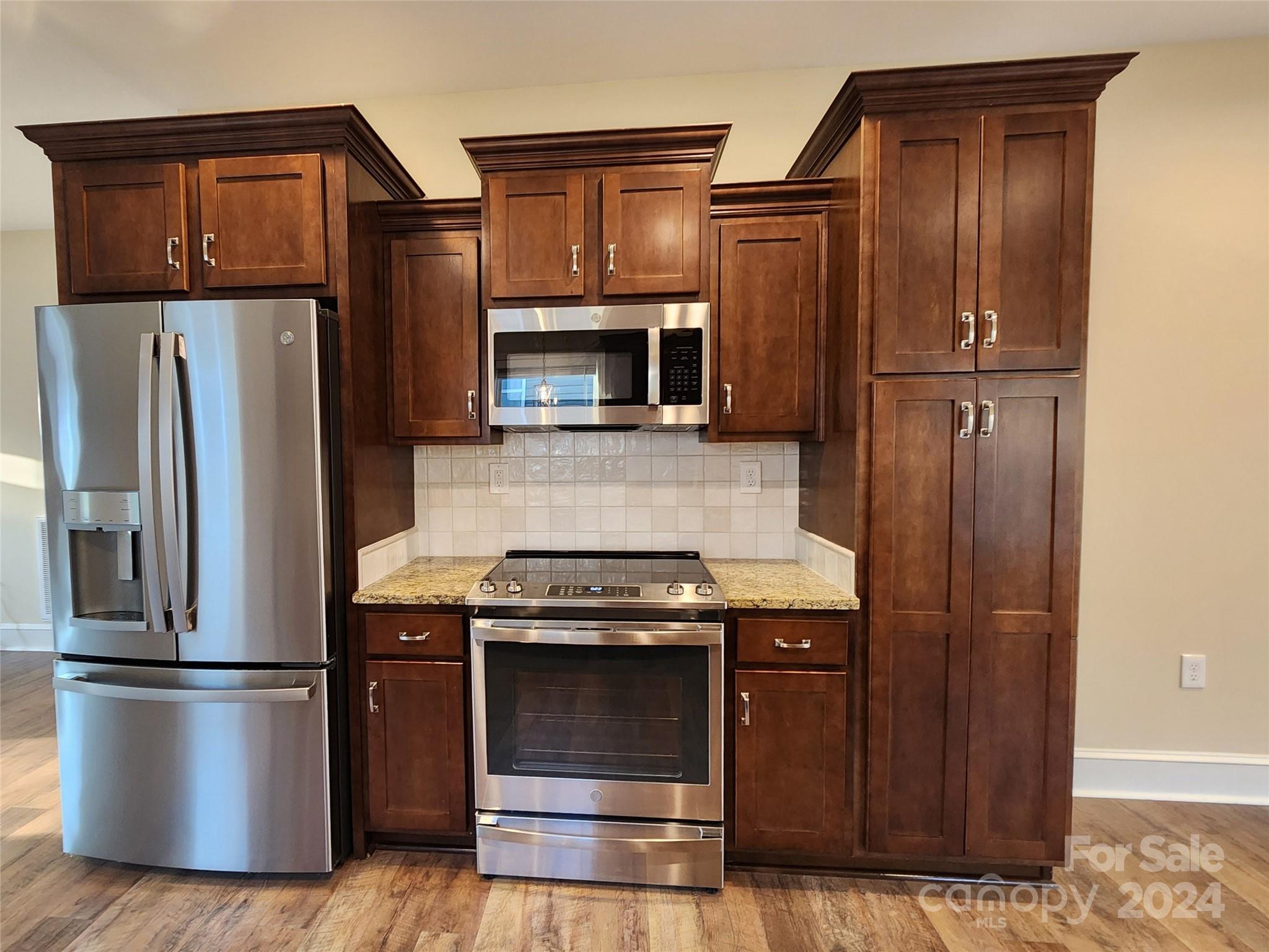 502 Tryon Street Greer, SC 29651 - Photo 6 of 31 a kitchen with stainless steel appliances granite countertop a refrigerator and a stove top oven