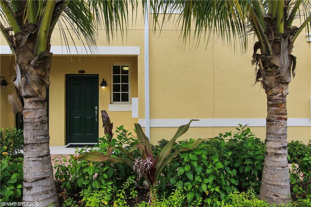 8540 Violeta Street, Unit 202 Estero, FL 34135 - Photo 1 of 22 front view of a house with a garden