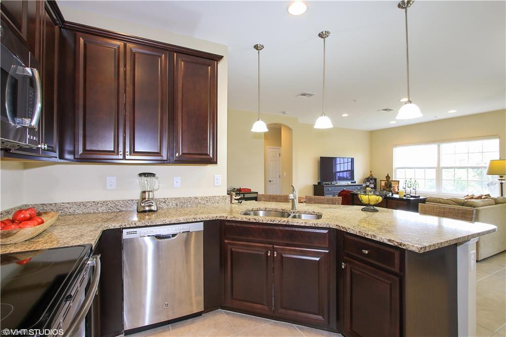8540 Violeta Street, Unit 202 Estero, FL 34135 - Photo 13 of 22 a kitchen with a sink and cabinets
