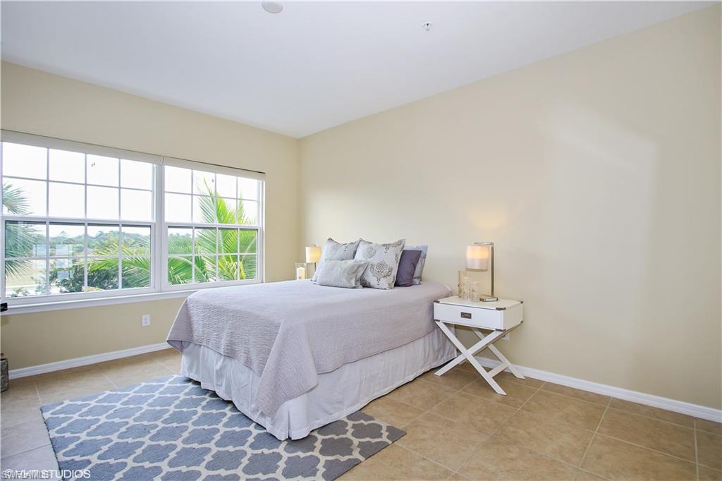 8540 Violeta Street, Unit 202 Estero, FL 34135 - Photo 14 of 22 a bedroom with a bed and a window