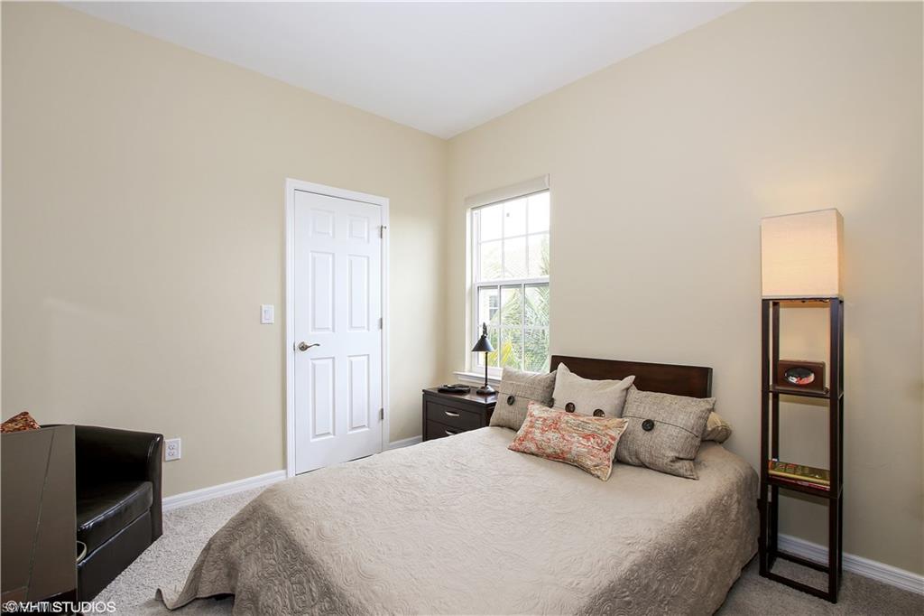 8540 Violeta Street, Unit 202 Estero, FL 34135 - Photo 16 of 22 a bedroom with a bed and a tv