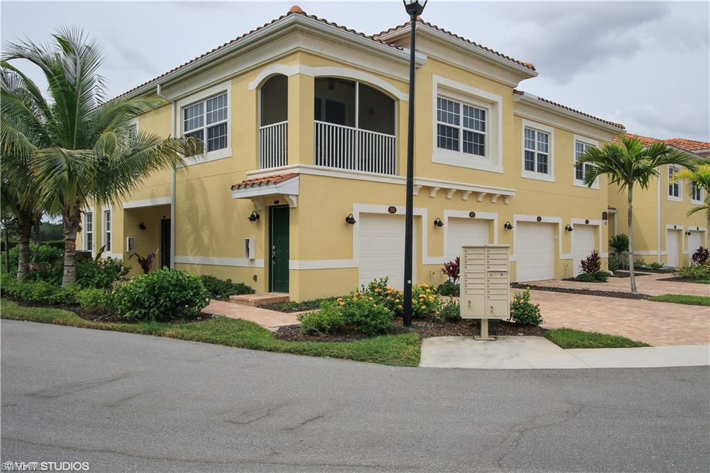 8540 Violeta Street, Unit 202 Estero, FL 34135 - Photo 22 of 22 a front view of a house with a yard and garage