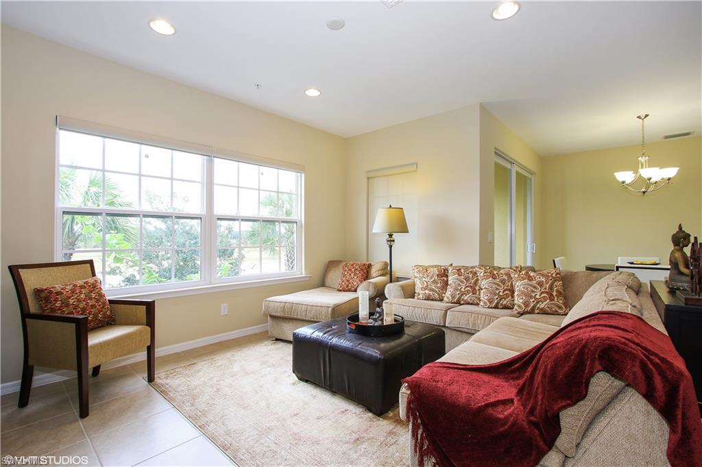 8540 Violeta Street, Unit 202 Estero, FL 34135 - Photo 6 of 22 a living room with furniture and a large window