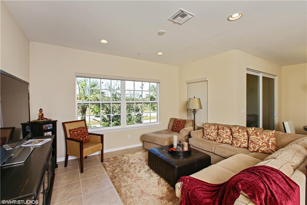 8540 Violeta Street, Unit 202 Estero, FL 34135 - Photo 7 of 22 a living room with furniture and a large window