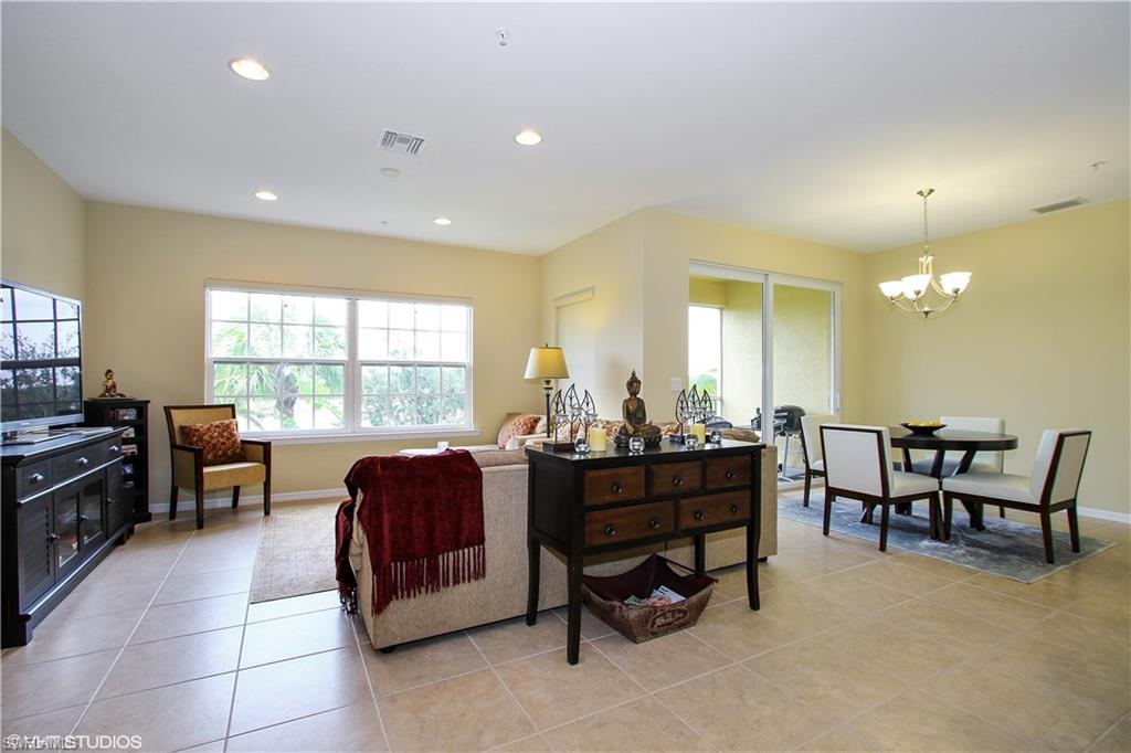8540 Violeta Street, Unit 202 Estero, FL 34135 - Photo 8 of 22 a living room with furniture and a large window