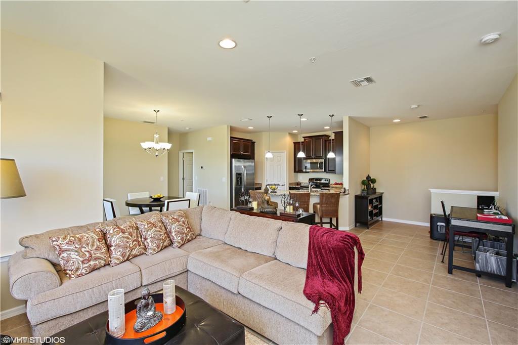 8540 Violeta Street, Unit 202 Estero, FL 34135 - Photo 10 of 22 a living room with furniture and kitchen view
