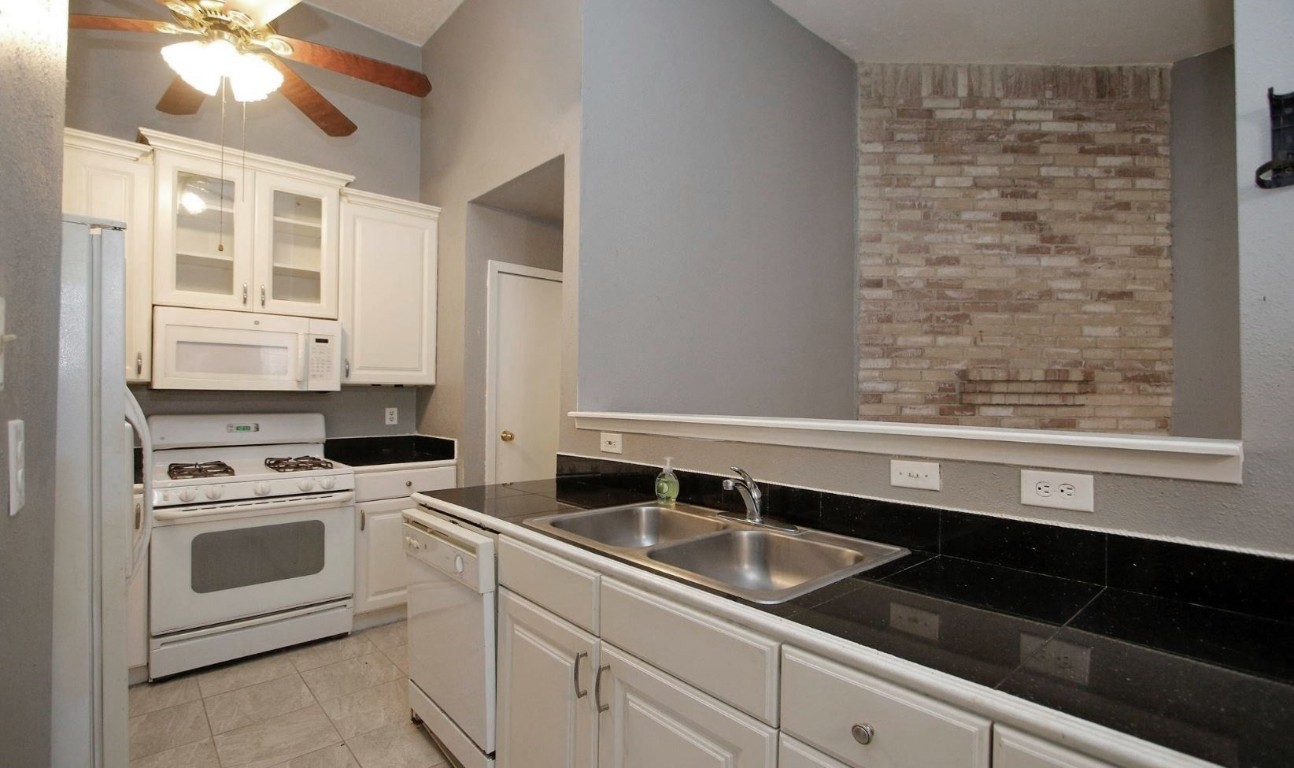 3111 Oak Rock Spring, TX 77373 - Photo 11 of 21 a kitchen with a sink stove and cabinets