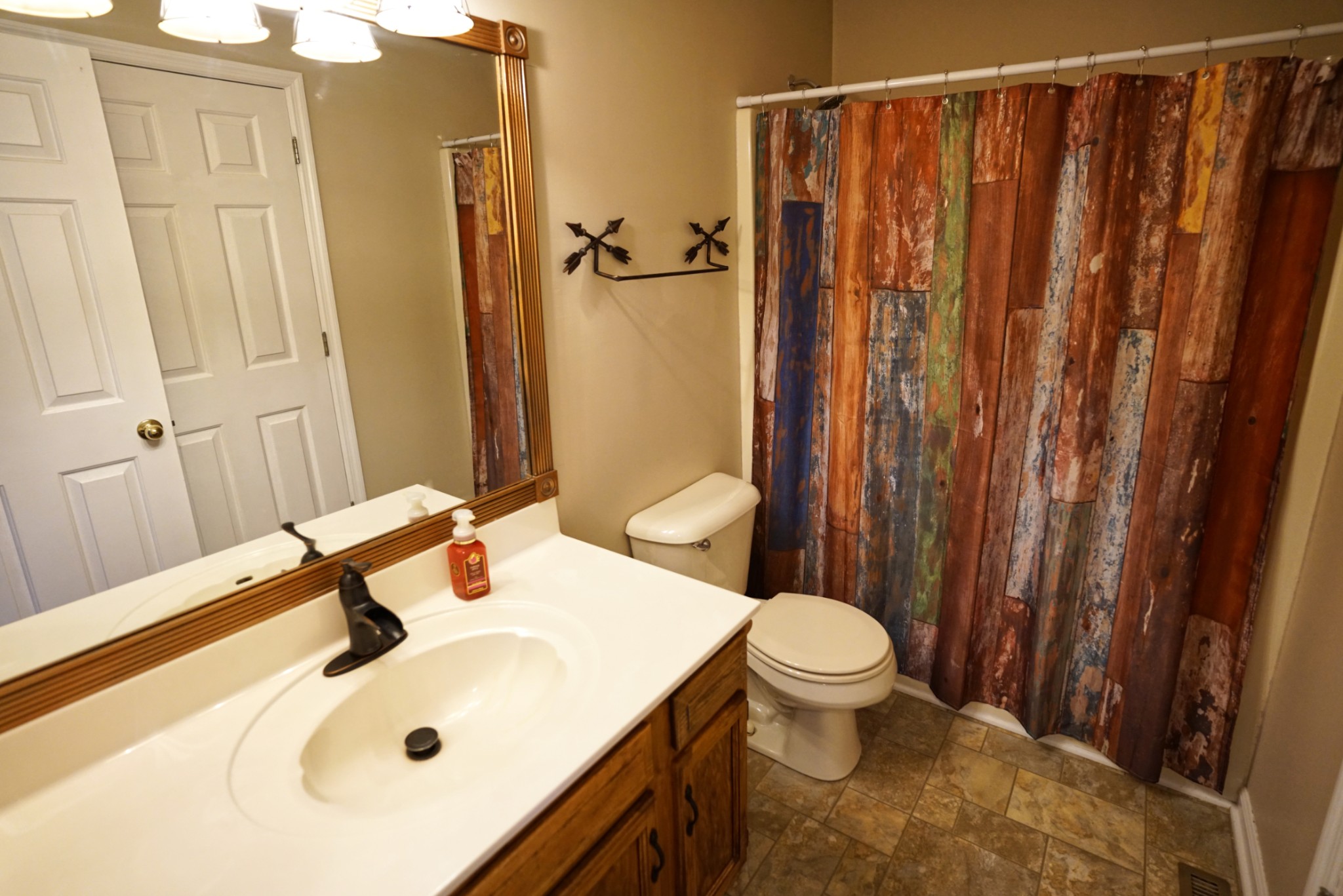 1168 West Grab Creek Road Dickson, TN 37055 - Photo 17 of 37 a bathroom with a sink a toilet and shower curtain