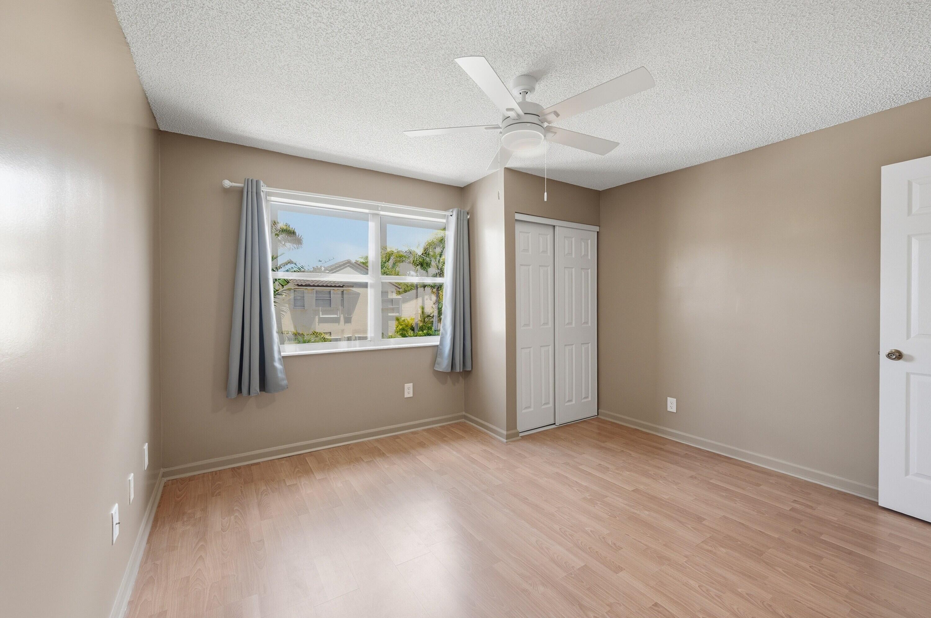 18474 Old Princeton Lane Boca Raton, FL 33498 - Photo 29 of 46 a view of an empty room with a window and wooden floor