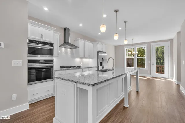 a view of a refrigerator in kitchen and wooden floor