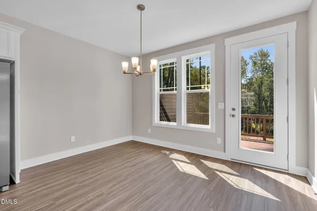 a view of a balcony with wooden floor and fence