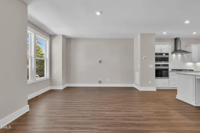 a view of a hallway with closet and mirror