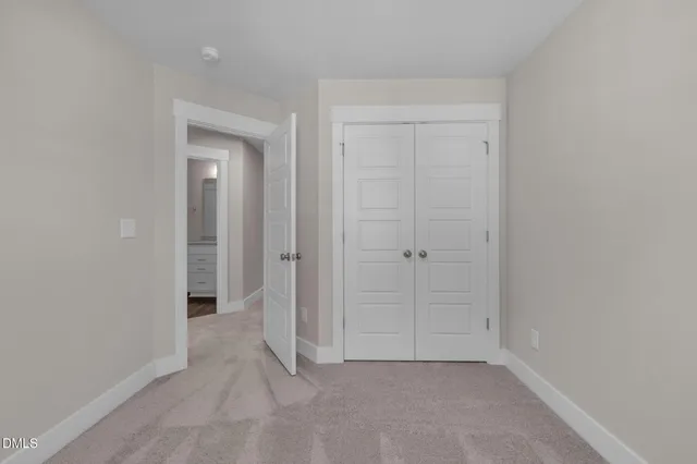 a view of staircase with white walls and door