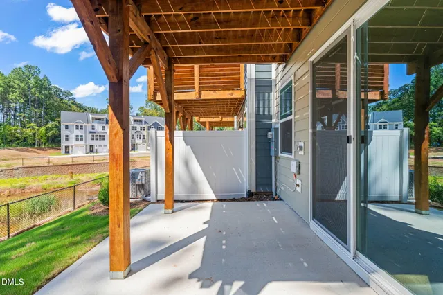 a view of a porch with chairs and backyard