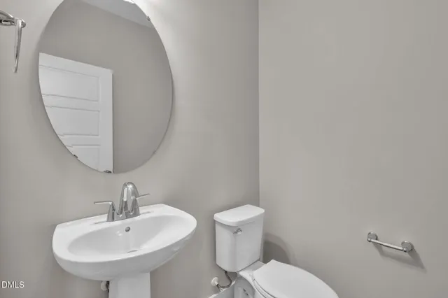 a kitchen with stainless steel appliances granite countertop a refrigerator a sink dishwasher a stove and white cabinets with wooden floor