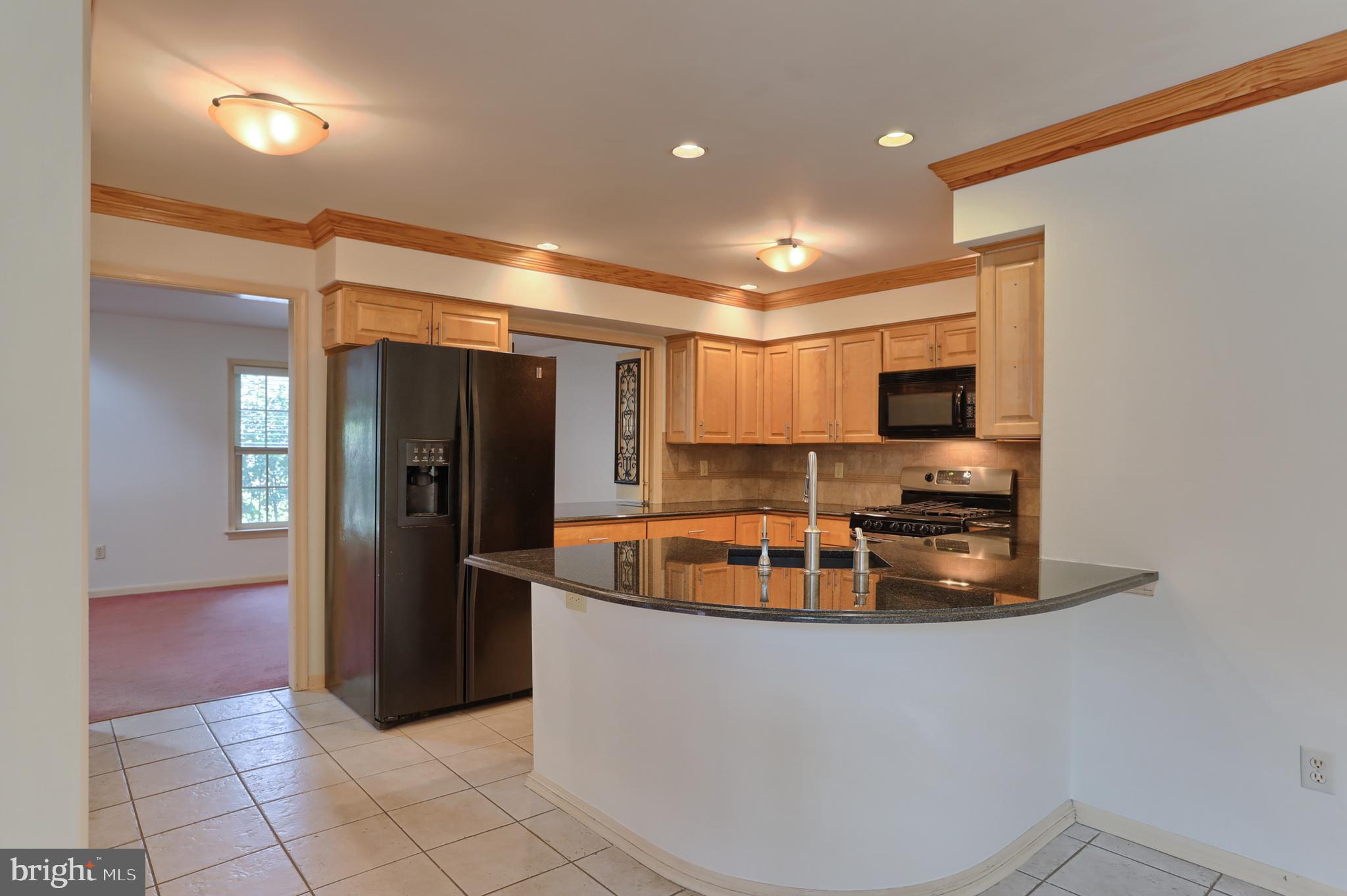 Remodeled kitchen with ceramic tile flooring